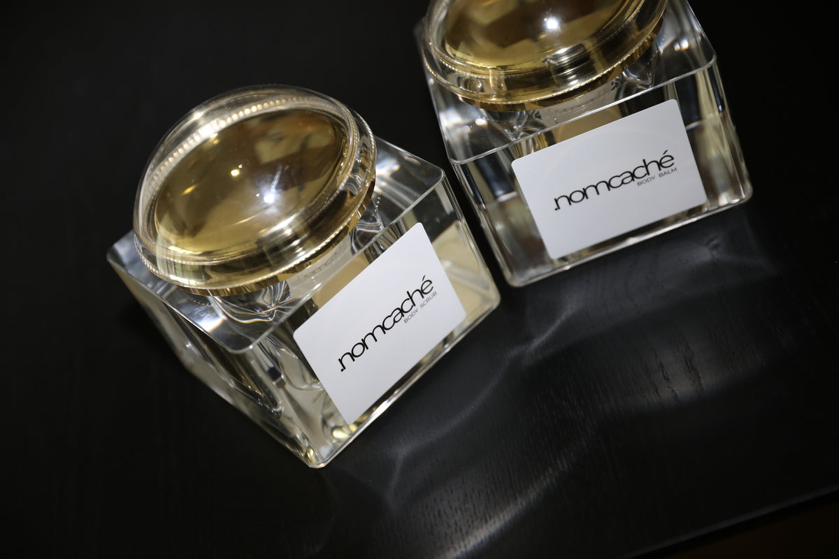 forma.nomcaché — body scrub and body balm in a dark setting
