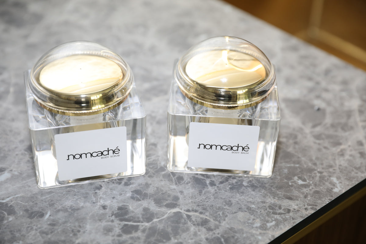 forma.nomcaché — body balm and body scrub on a stone surface